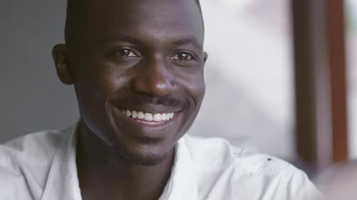 Handsome Young Man Talking and Smiling Indoors