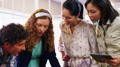 Team Collaborating on Laptop in Modern Office