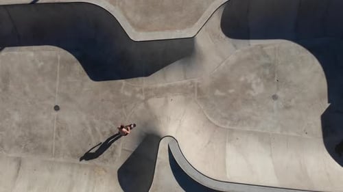 Anonymous person riding skateboard in skate park