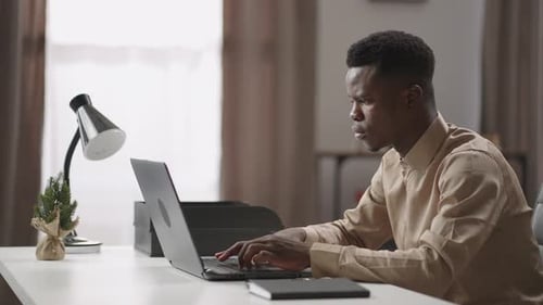 Man Working on Laptop at Office Desk