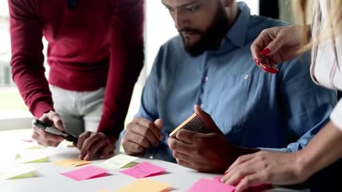 Brainstorming Session with Sticky Notes in a Bright Office