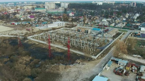Electric substation with tall pylons and hog voltage distribution cables. Industrial concept