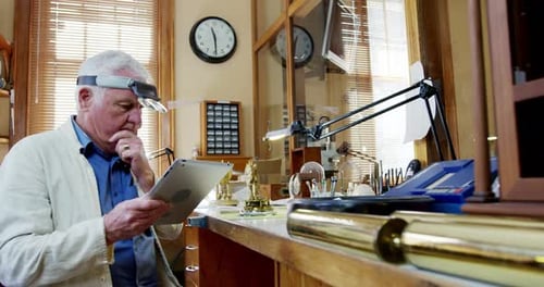 Man Working at Workbench with Tablet and Tools