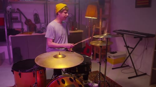 Modern Man Playing Drums In Garage