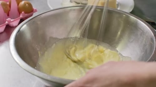 Eggs and Liquid Whisked in Metal Bowl