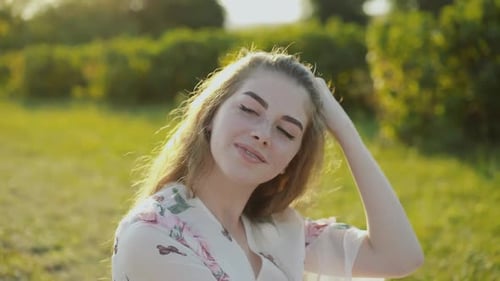 Smiling Teen Woman in a Sunny Field