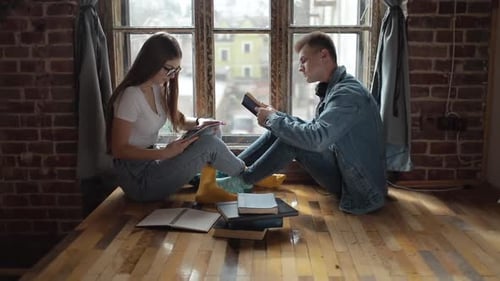 Young Students Using Tablet and Books for Learning