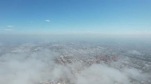 Aerial Cityscape with Clouds and Blue Sky