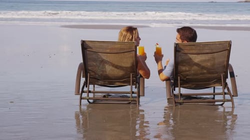 Couple with tropical cocktails at beach. Shot on RED EPIC for high quality 4K, UHD, Ultra HD resolut