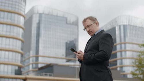 Funny Plump Man in Suit Texting on Smartphone and Looking Into Camera, Adult Manager Outside Office