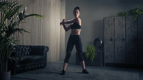 Woman Stretches Before Fitness Workout Indoors