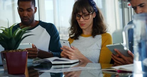 Executives using mobile phone and digital tablet