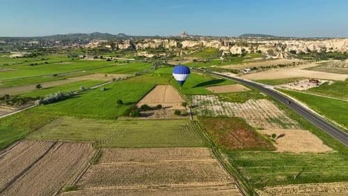 4K Aerial view of Goreme. Colorful hot air balloons fly over the valleys.