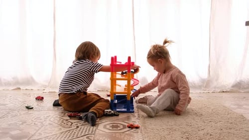Children Playing with Toy Garage Indoors