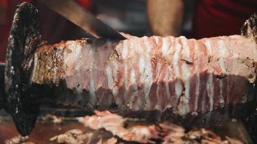 Closeup Man Hands Cutting Grilled Meat. Male Chef Hands Preparing Shawarma