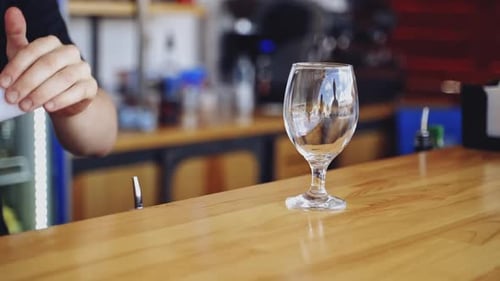 Glass Being Filled with Ice at a Bar