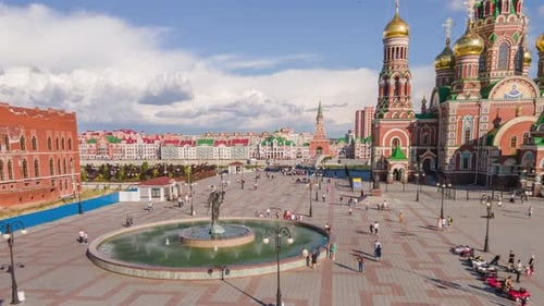 Square in modern city. People walk at fountain. Orthodox church. Drone footage