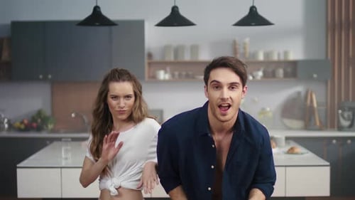 Young Couple Dancing Together in Kitchen