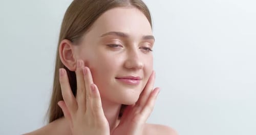 Woman Touching Face Gently in Beauty Shot