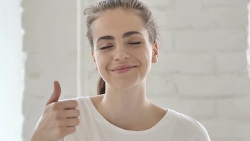 Thumbs Up By Young Woman