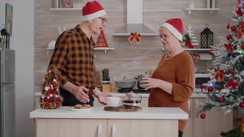 Family Exchanging Christmas Gifts in Decorated Kitchen