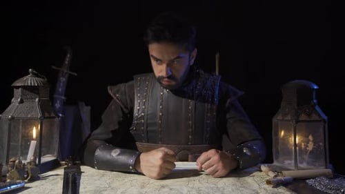 Man in Armor Studies Map by Candlelight