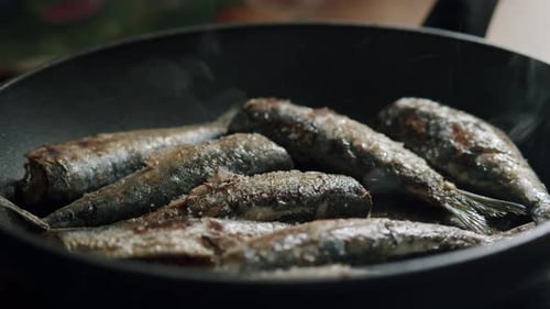 Small Fish Cooking in a Frying Pan