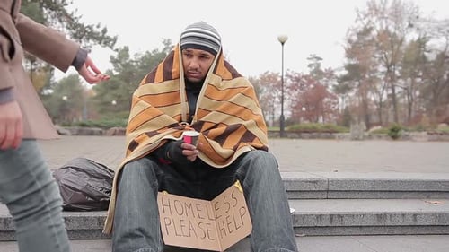 Kind Young Woman Giving Money to Poor Homeless Man Begging for Help in Street