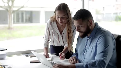 Focused Friendly Business Colleagues Using Laptop Together