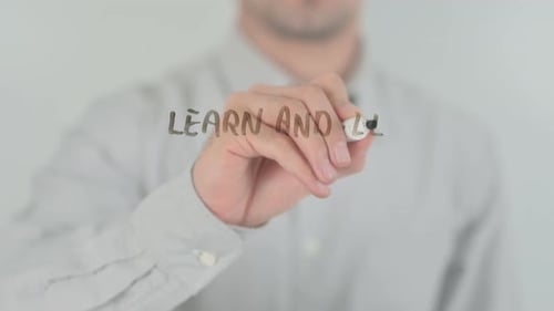 Man Writes Learn and Lead with Marker