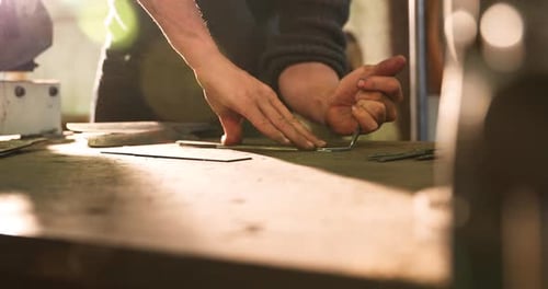 Metalworker Measures Sheet Metal in Workshop, Close Up