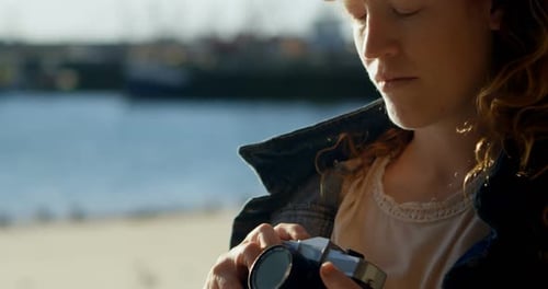 Woman Clicking Photo with Camera at Dock