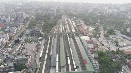 Railway and train station in the center of Guwahati city in India, city landscape seen from above