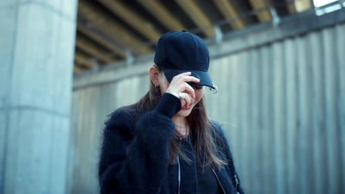 Girl Flirting with Camera Outdoors. Woman Playing with Hair at Windy Weather