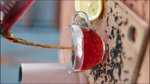 Close-up Tea Pouring into Clear Glass Mug