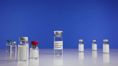 COVID-19 Vaccine Vials on Blue Background