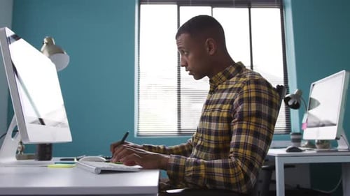 Mixed race man working on computer