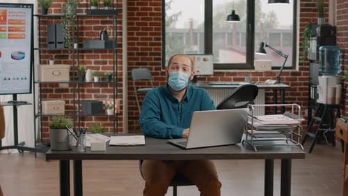 Man Working at Laptop in Office Bumps Elbows