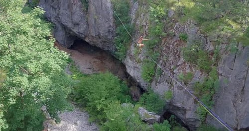 Highline Walker Balances Above Rocky Gorge