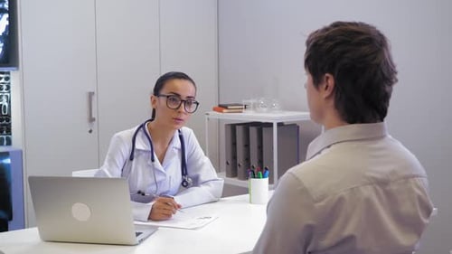 Therapist Talking with Male in Hospital