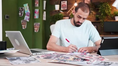 Man Working at Desk Using Tablet and Laptop