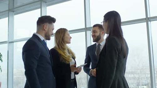 Business Team Discussing Data on Tablet Indoors
