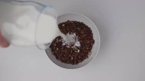 Milk Poured into Bowl of Granola and Berries