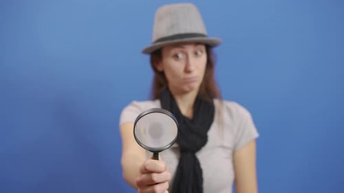 Funny Girl Looking Throw Magnifier To the Camera