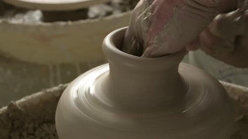 Potter moulant un vase de boue dans le tour