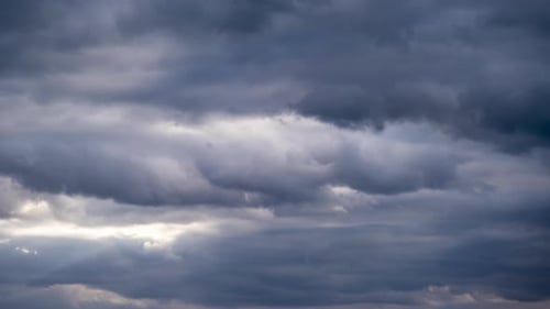 Storm Clouds Passing Overhead with Dramatic Sunlight