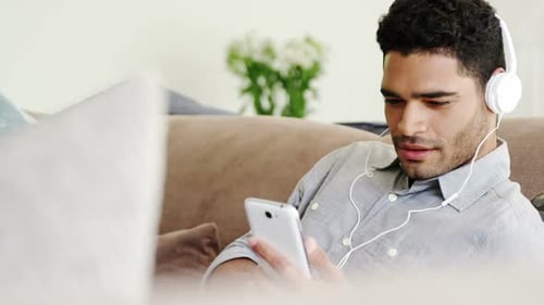 Young Man Listening to Music on Smartphone