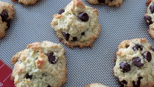 Panning over a tray of freshly baked homemade chocolate chip cookies. - Cookies fresh out of oven on