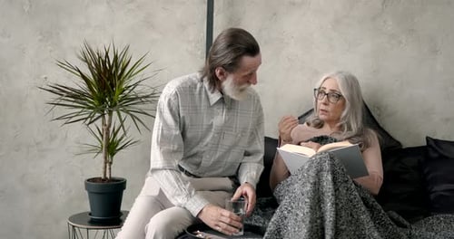 Caring Husband Giving Medicine to Wife at Home