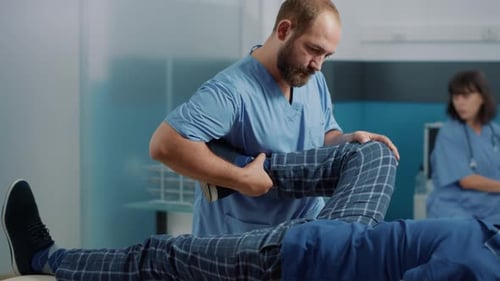 Healthcare Professional Manipulating Patient's Leg for Medical Treatment